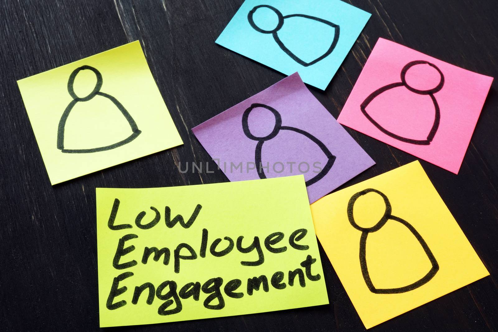 Low employee engagement. Stack of memo sticks. by designer491