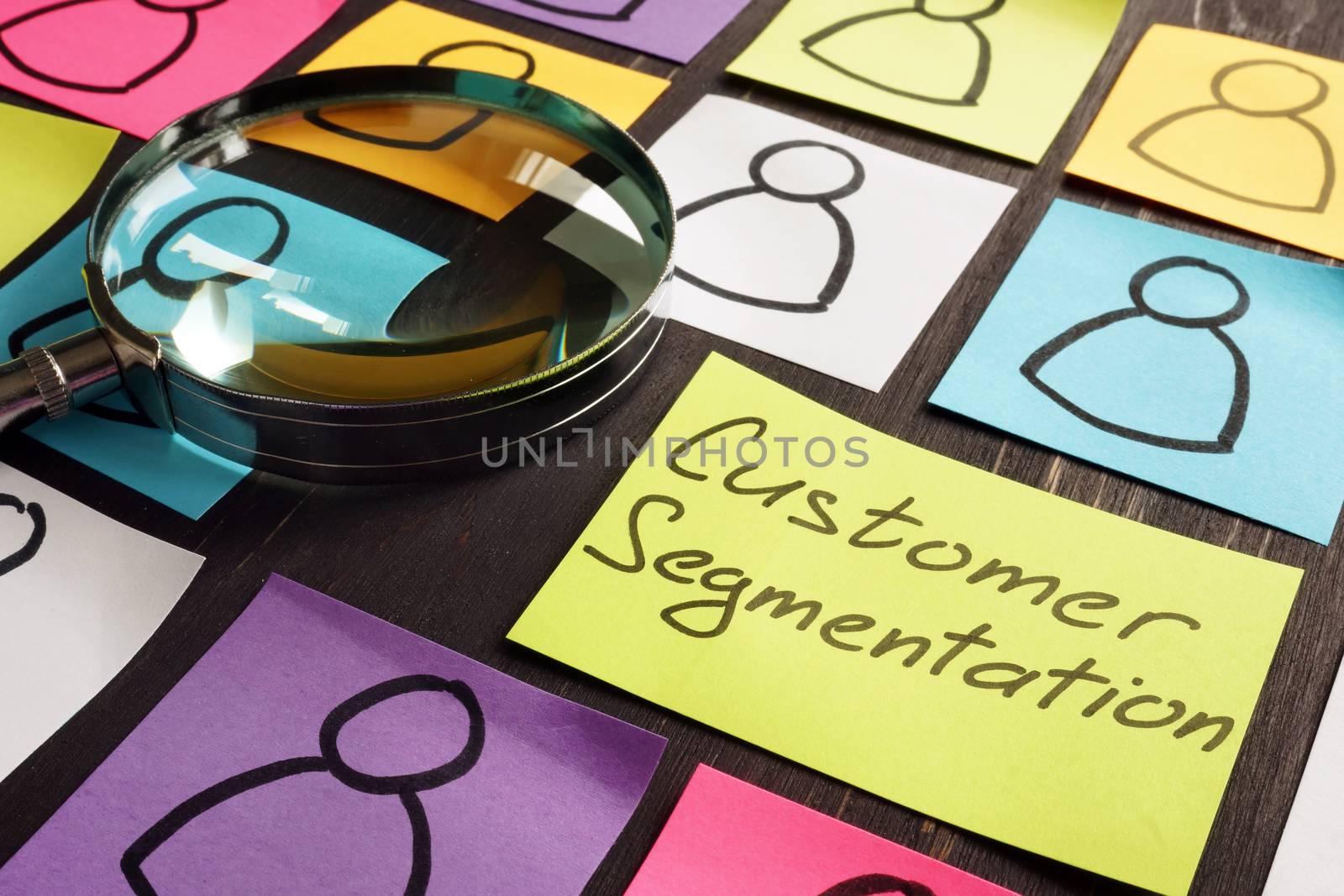 Customer Segmentation marketing concept. Magnifying glass and papers. by designer491