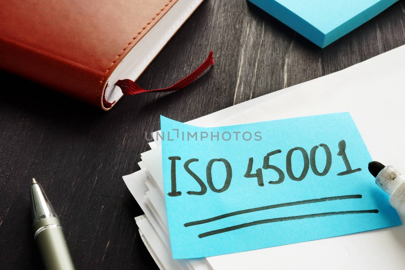 ISO 45001 handwritten on the piece of paper. by designer491