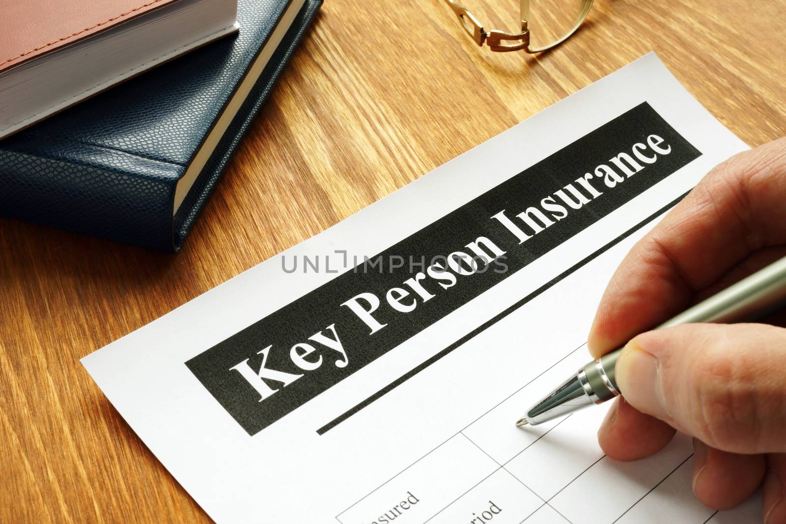 Key Person Insurance policy agreement on teble. by designer491