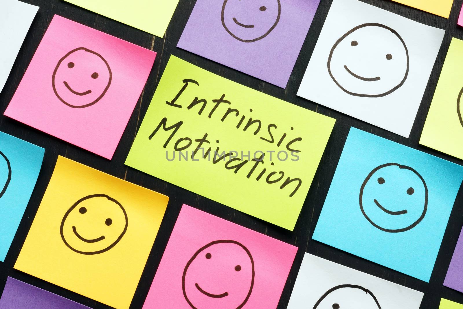 Intrinsic motivation concept. Color memo sticks with faces.