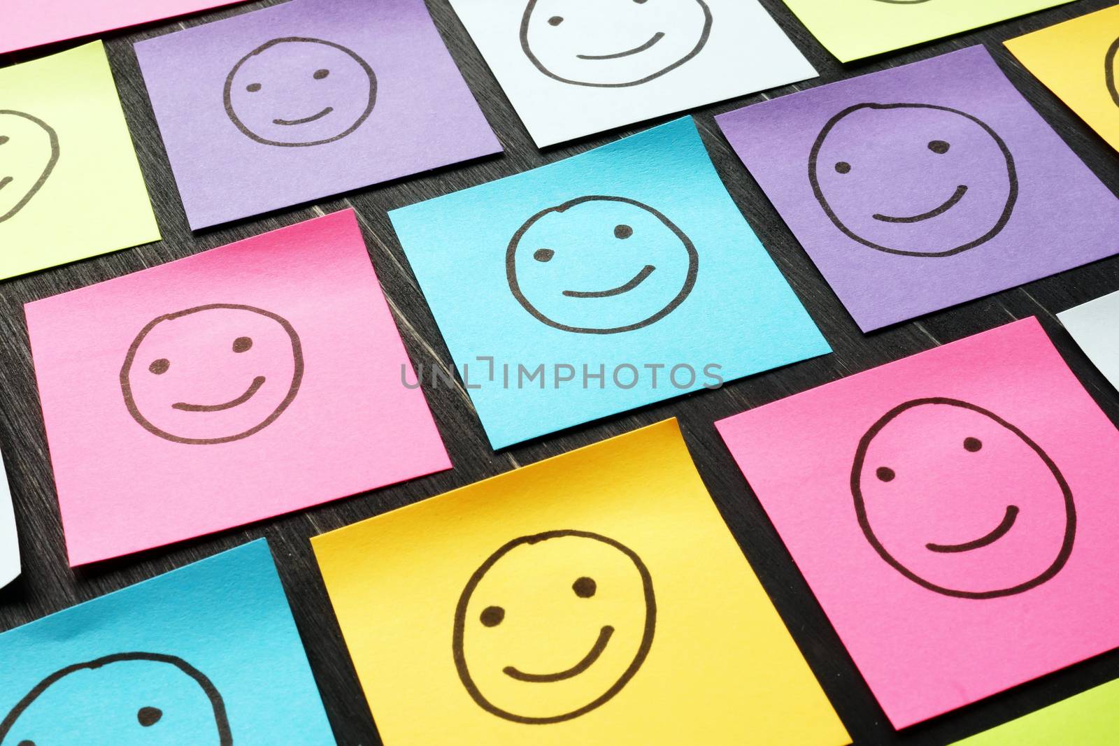 Smiling happy faces drawn on sheets. Customer Experience and evaluation concept.