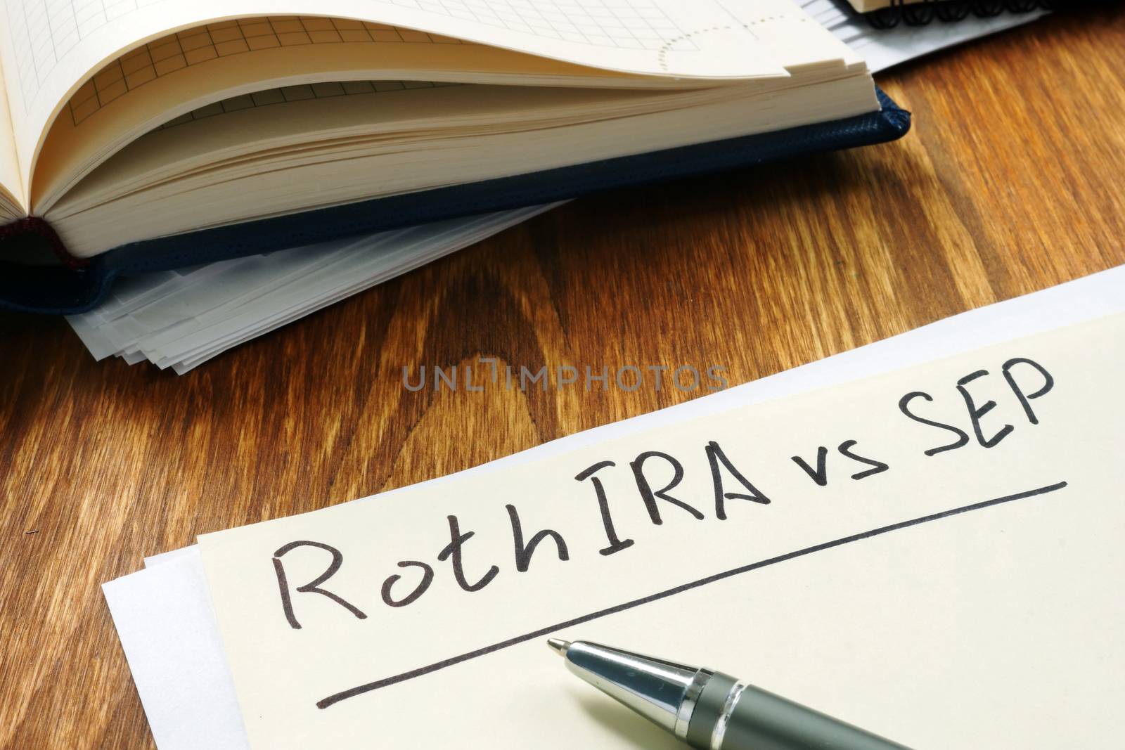 Roth IRA vs SEP handwritten on the yellow sheet. by designer491
