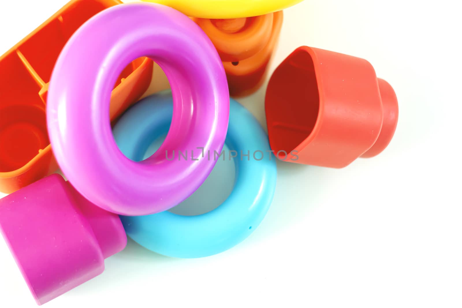 Colored plastic rings and rubber bricks for children to play. Children's toys. Growth and learning