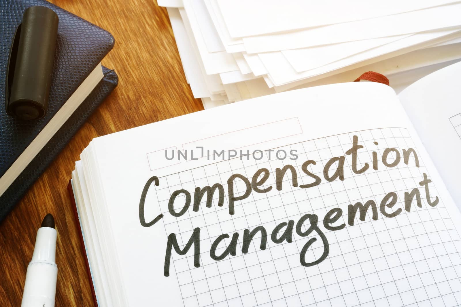Compensation management concept. Book and papers in the office. by designer491