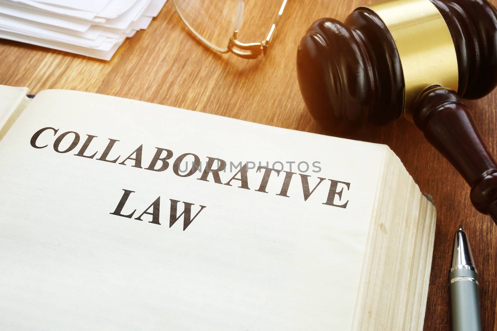 Collaborative law book, gavel and papers.