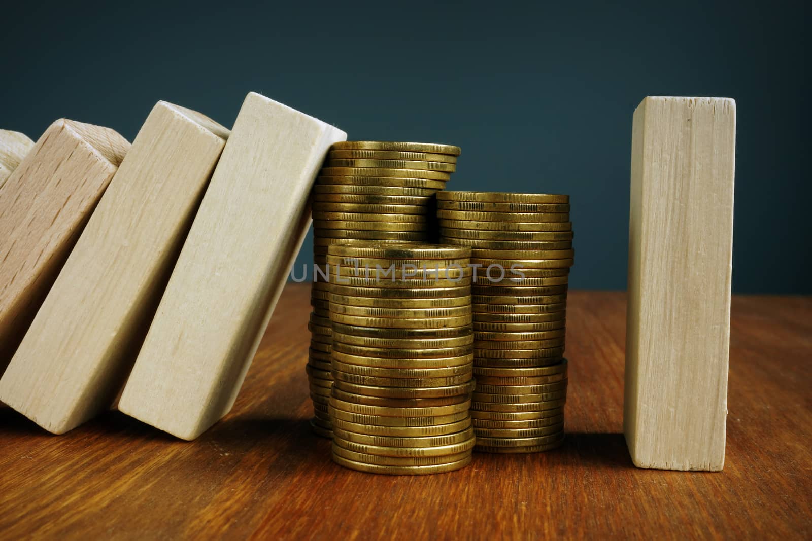 Financial stability and savings. Wooden blocks and stack of coins.