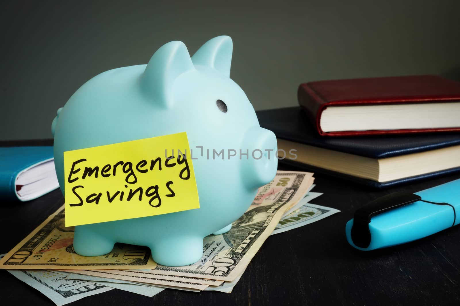 Emergency savings sign on the blue piggy bank. by designer491