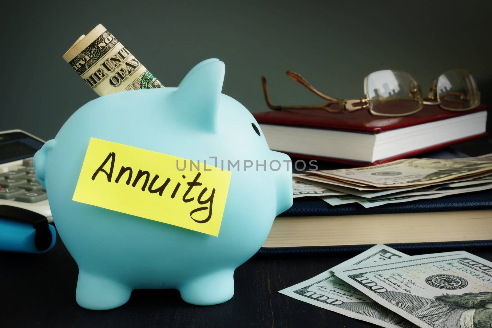 Annuity written on yellow sheet and piggy bank with money. by designer491
