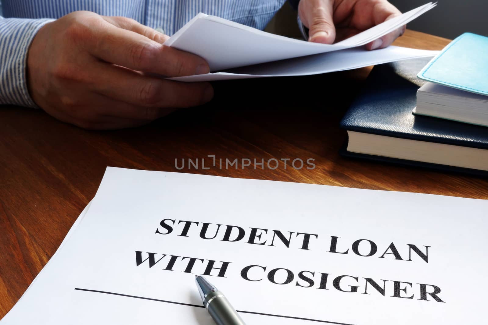 Student loans with cosigner application form and pen.