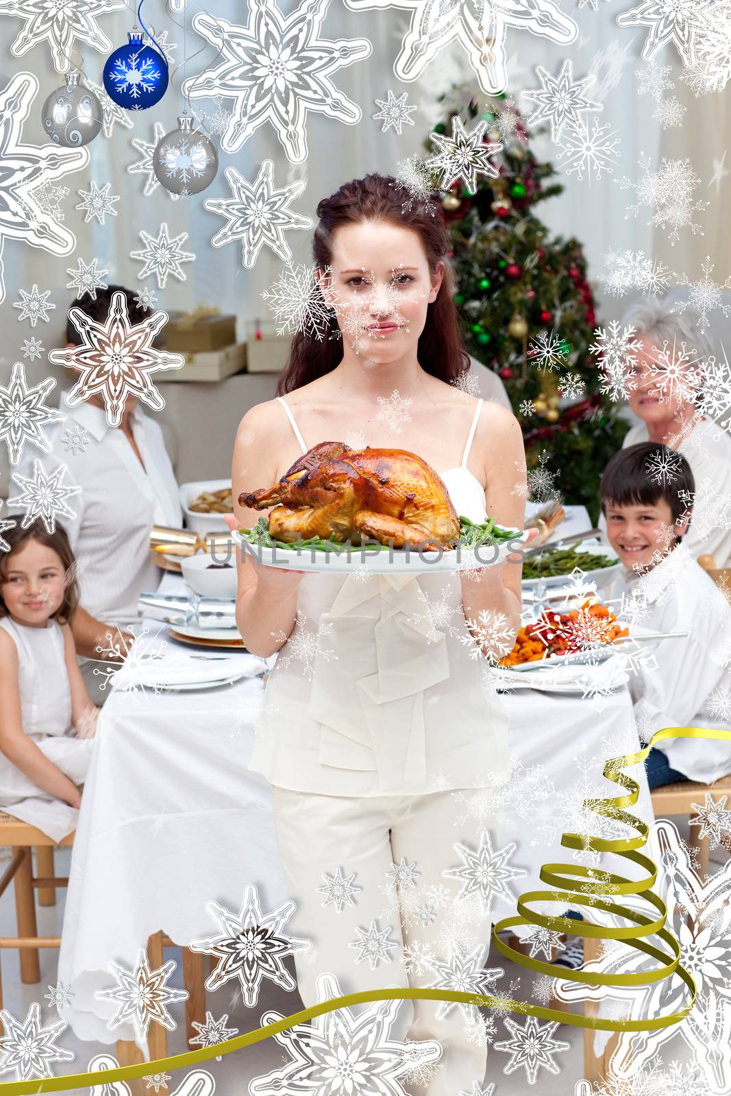 Mother showing turkey for Christmas dinner against snow falling