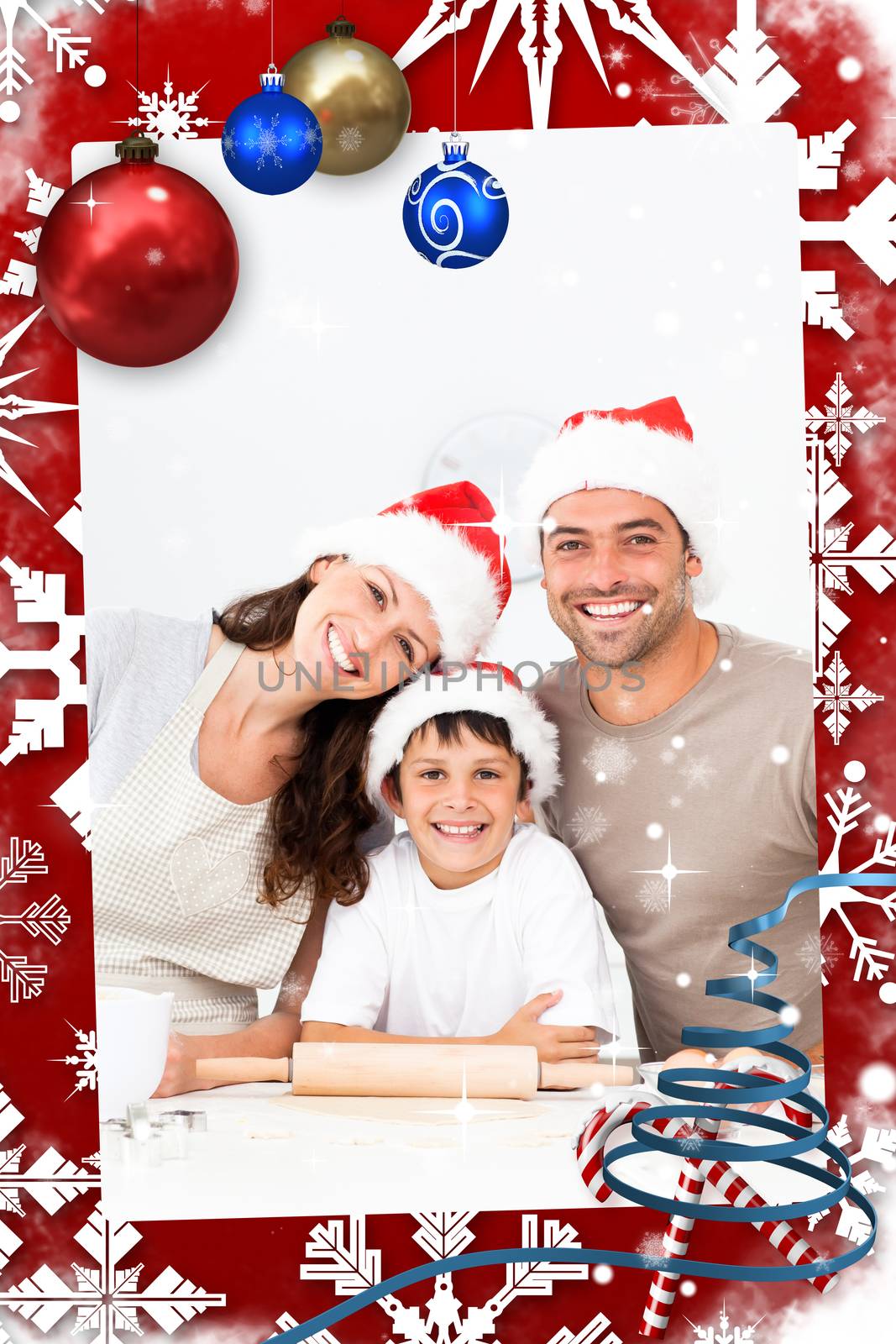 Happy family baking christmas cookies together against snow falling