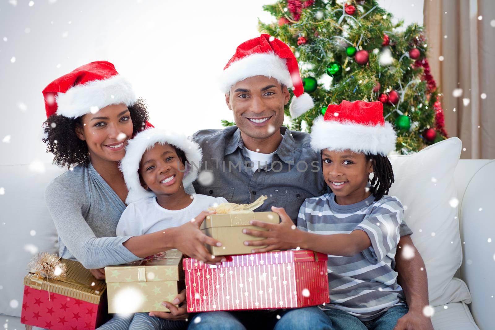 Smiling family sharing christmas presents by Wavebreakmedia