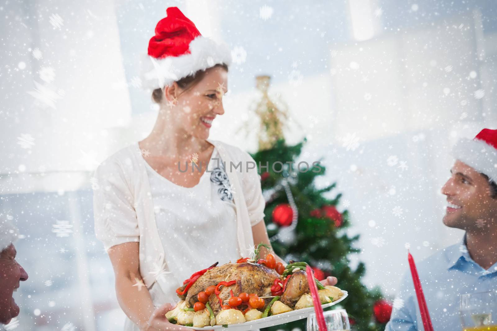 Cheerful woman wearing santa hat and bringing a roast chicken against snow
