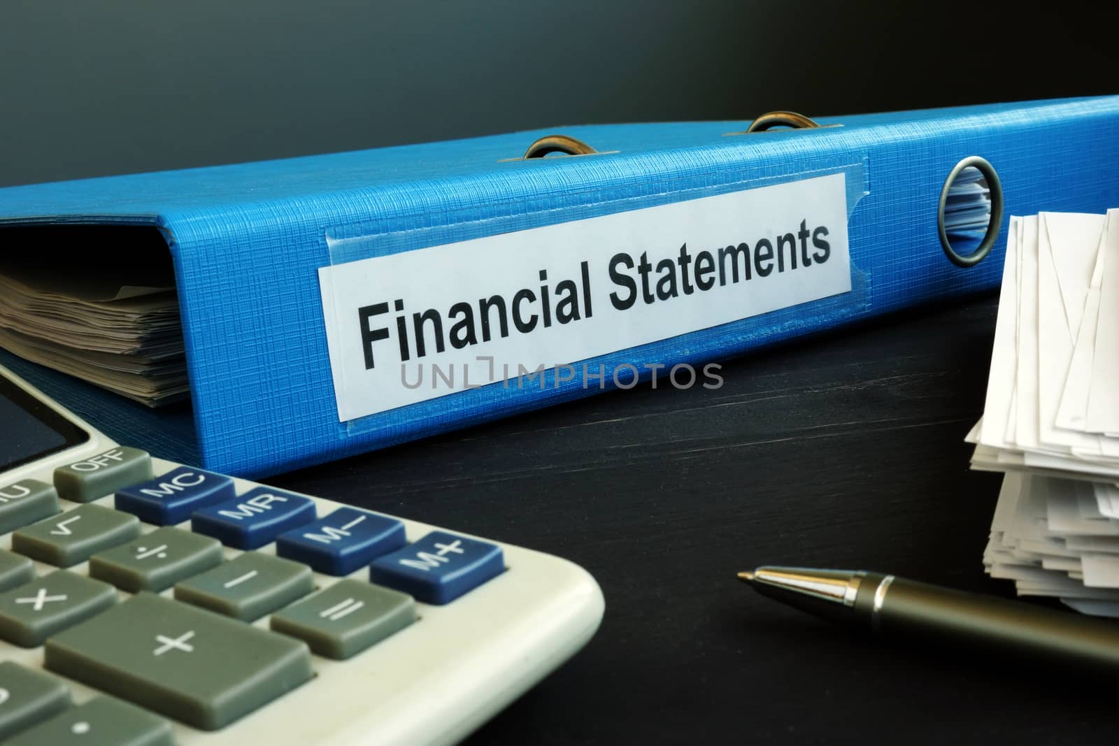 Blue folder with Financial Statements in the office. by designer491