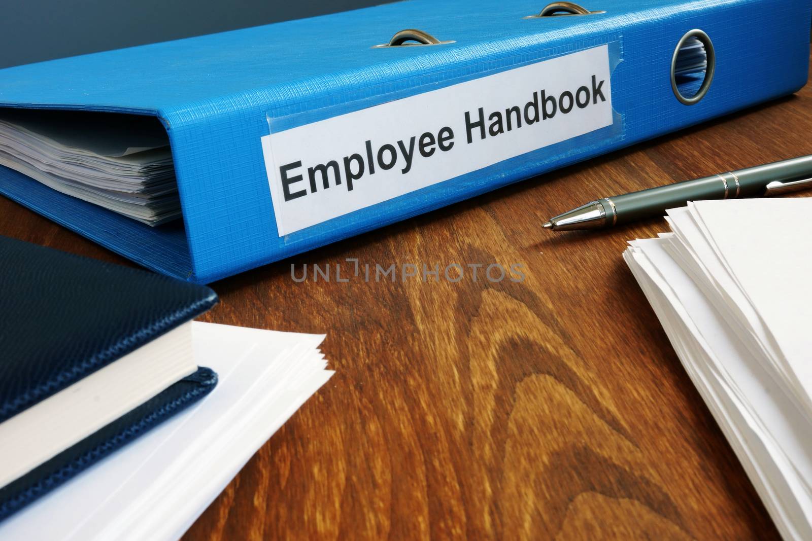 Employee Handbook manual in folder and documents. by designer491