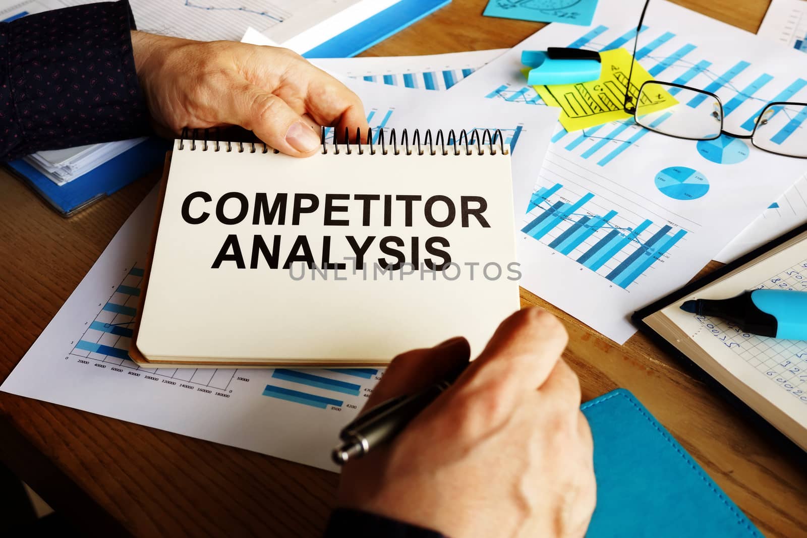 Competitor analysis report in the man hands. by designer491
