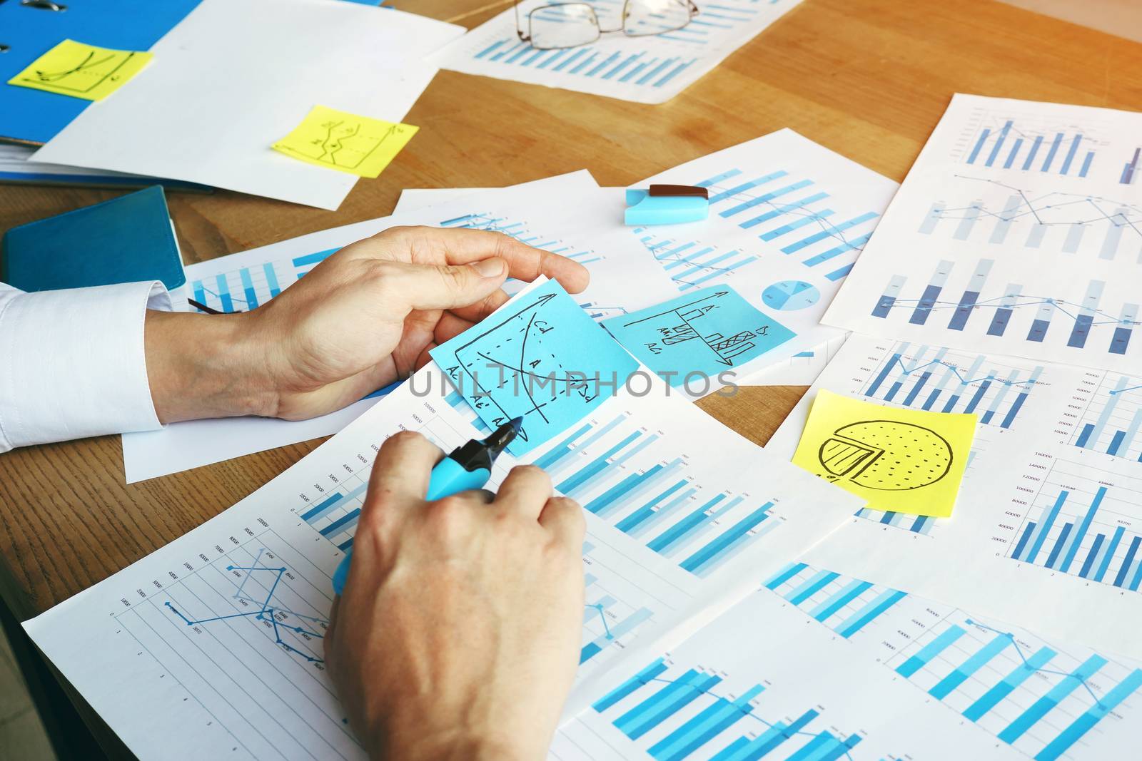 Auditor is checking financial report with charts and business graphs. by designer491