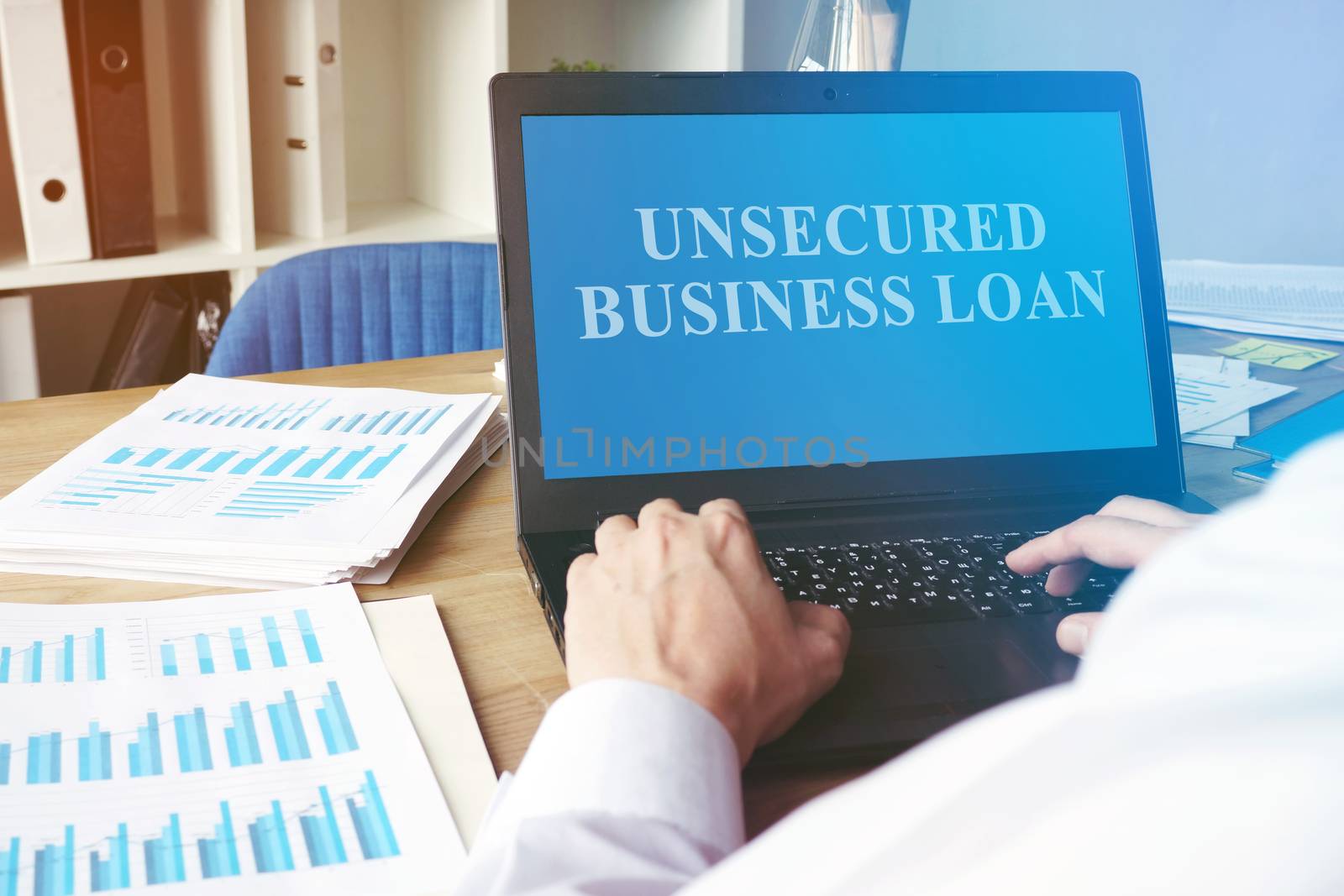 Unsecured Business Loan concept. Man with the laptop.