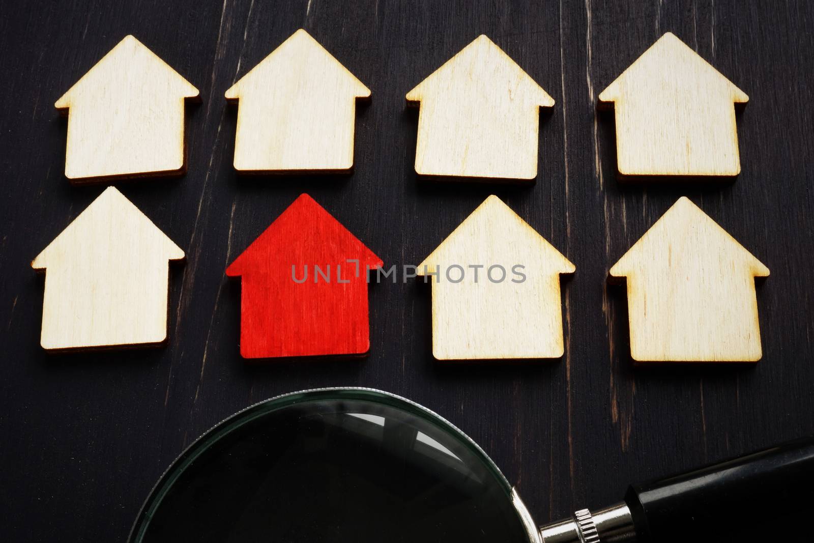 Real estate appraisal concept. Red home model and magnifying glass. House hunting. by designer491