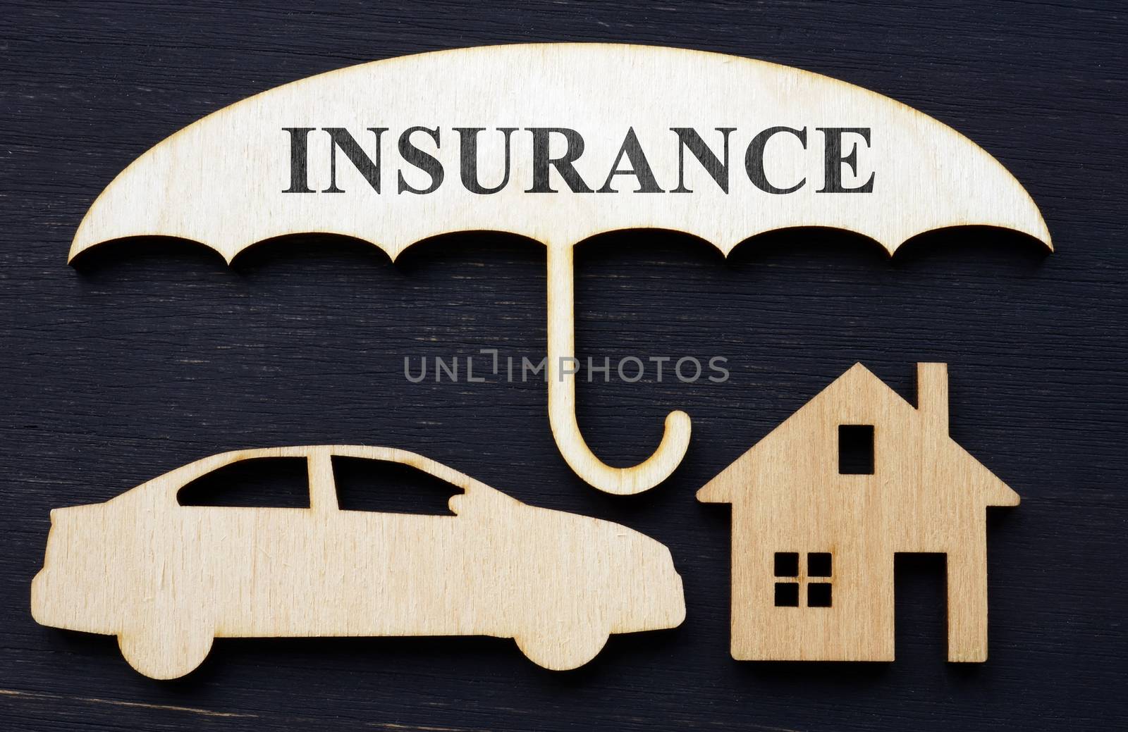 Comprehensive car and home insurance. Wooden umbrella and models.