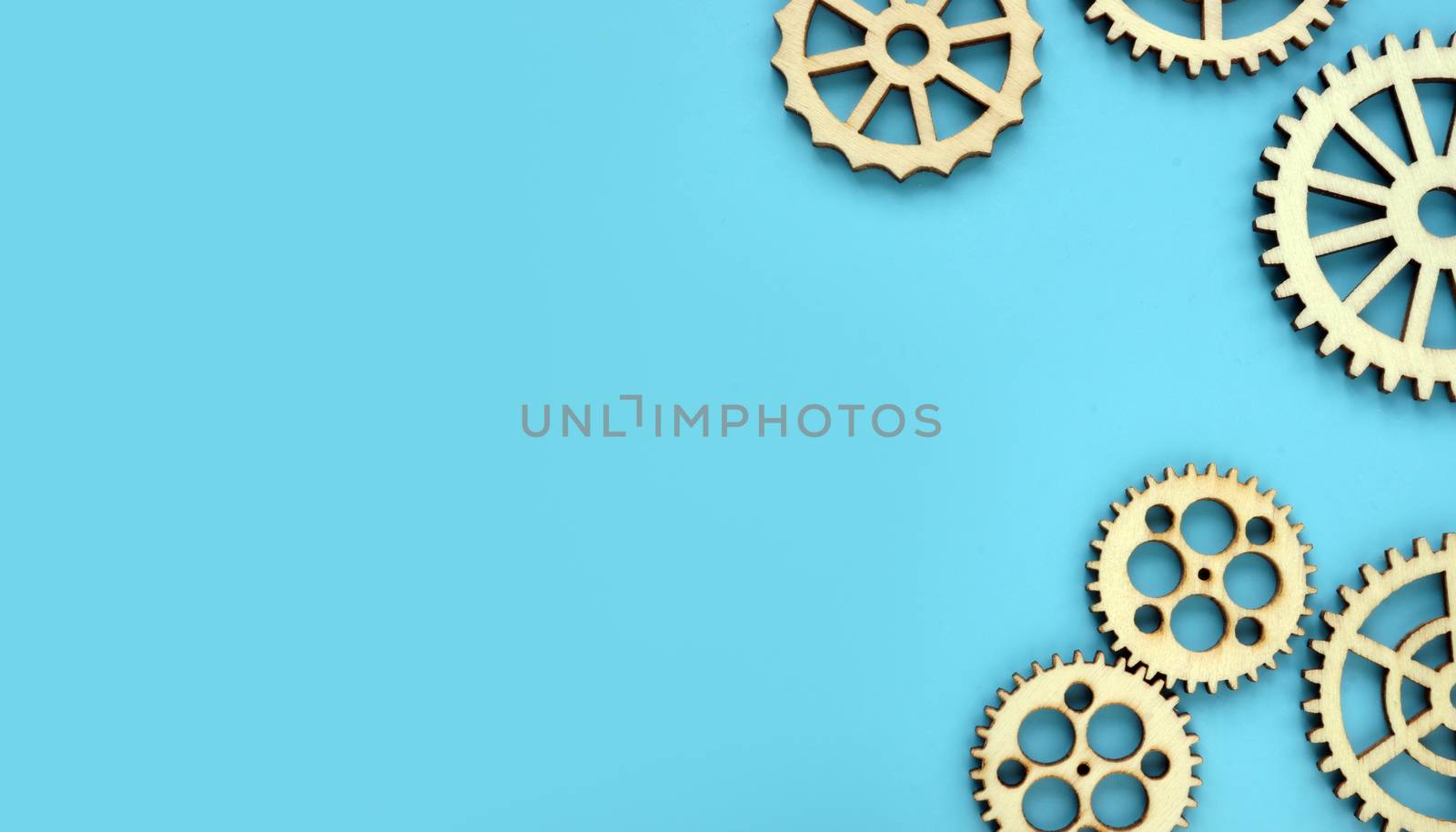 Blue background with wooden gears. Mind works and new ideas concept. Free space.