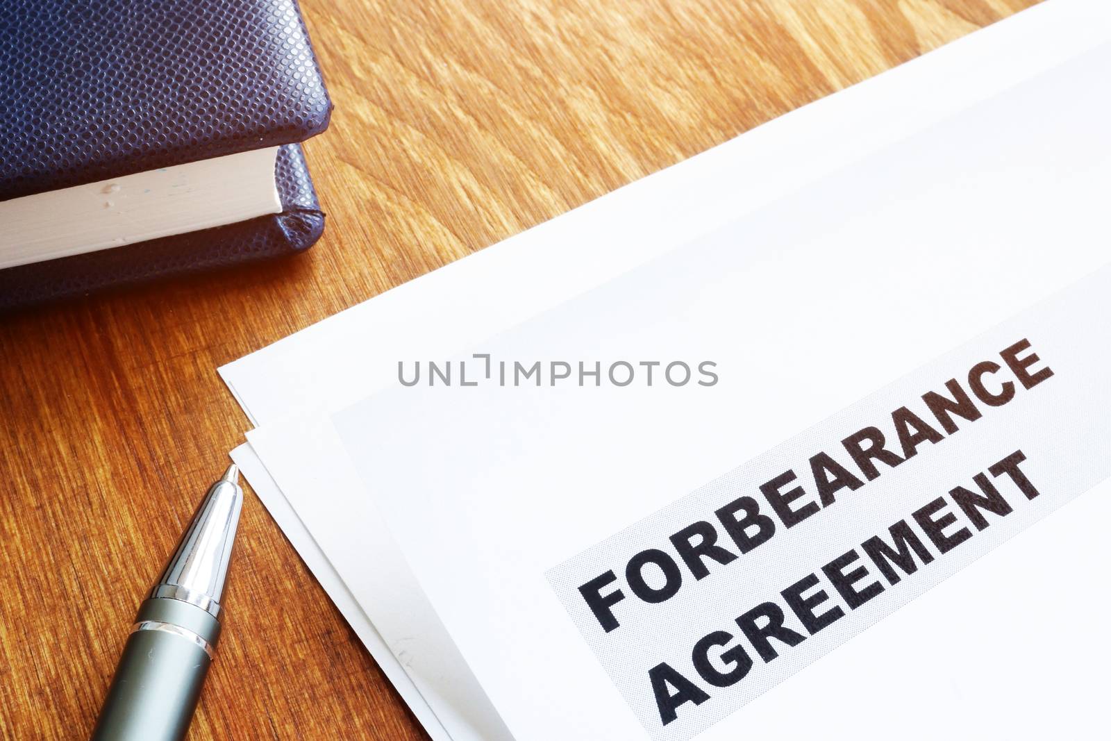 Forbearance agreement papers with pen and notepad. by designer491