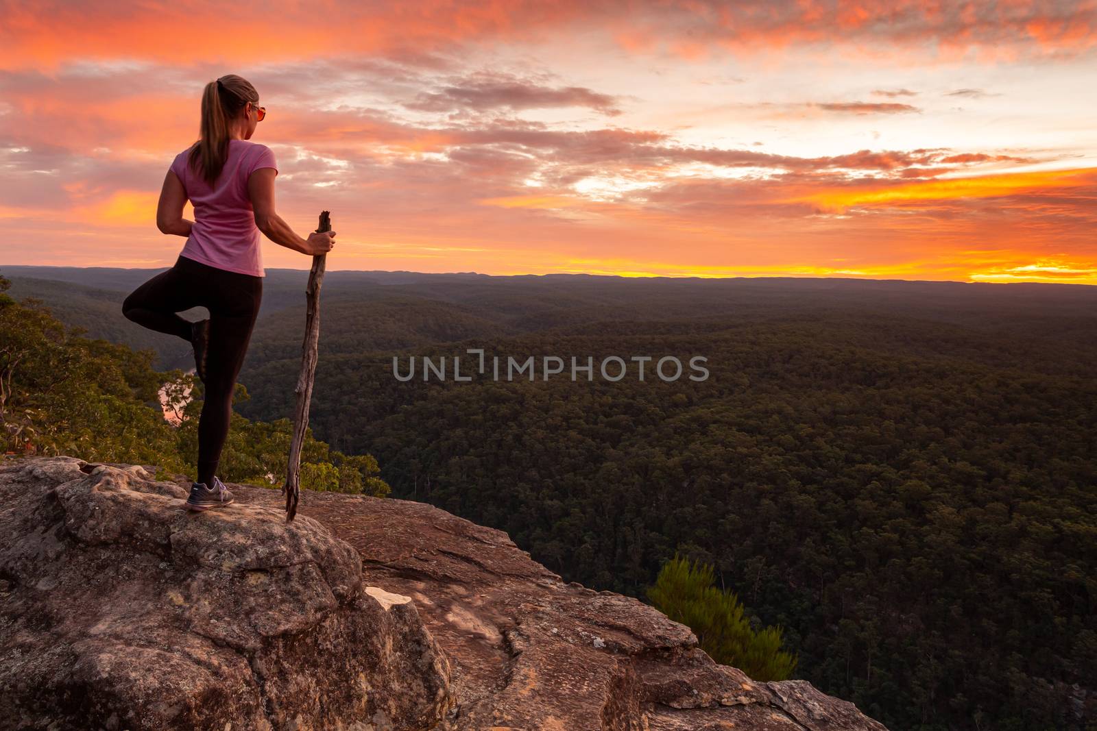 Woman mountain top serenity yoga native style while watching magnificent sunset by lovleah