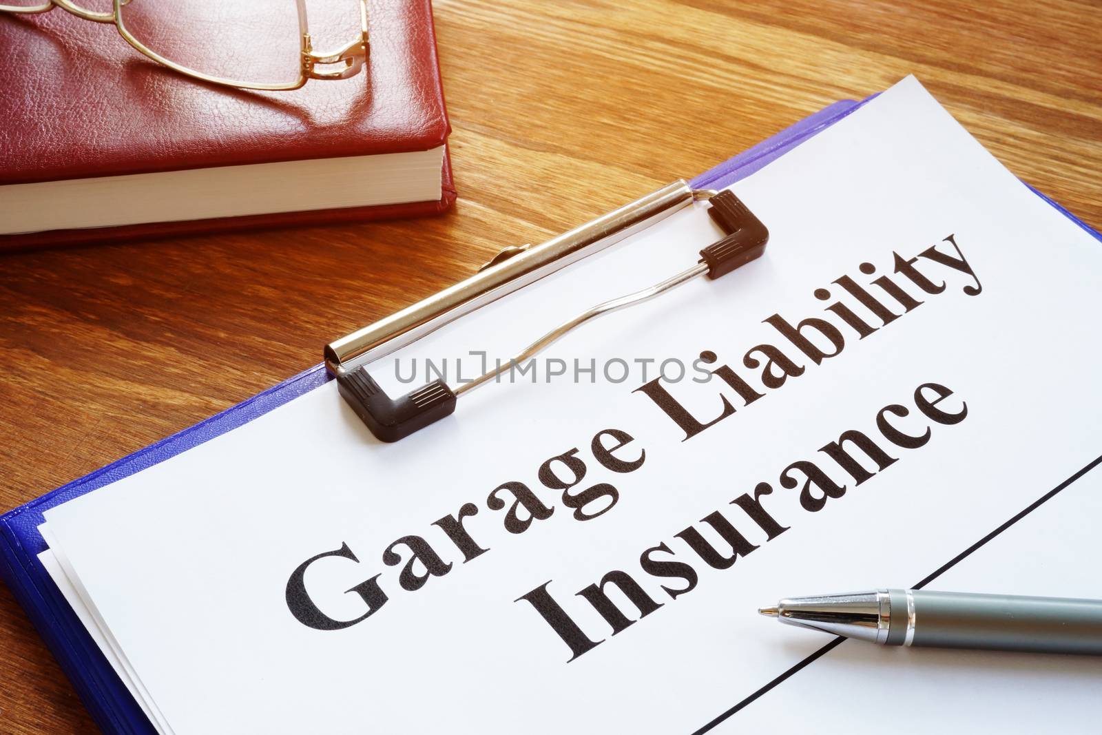 Garage Liability Insurance agreement and pen for signing.