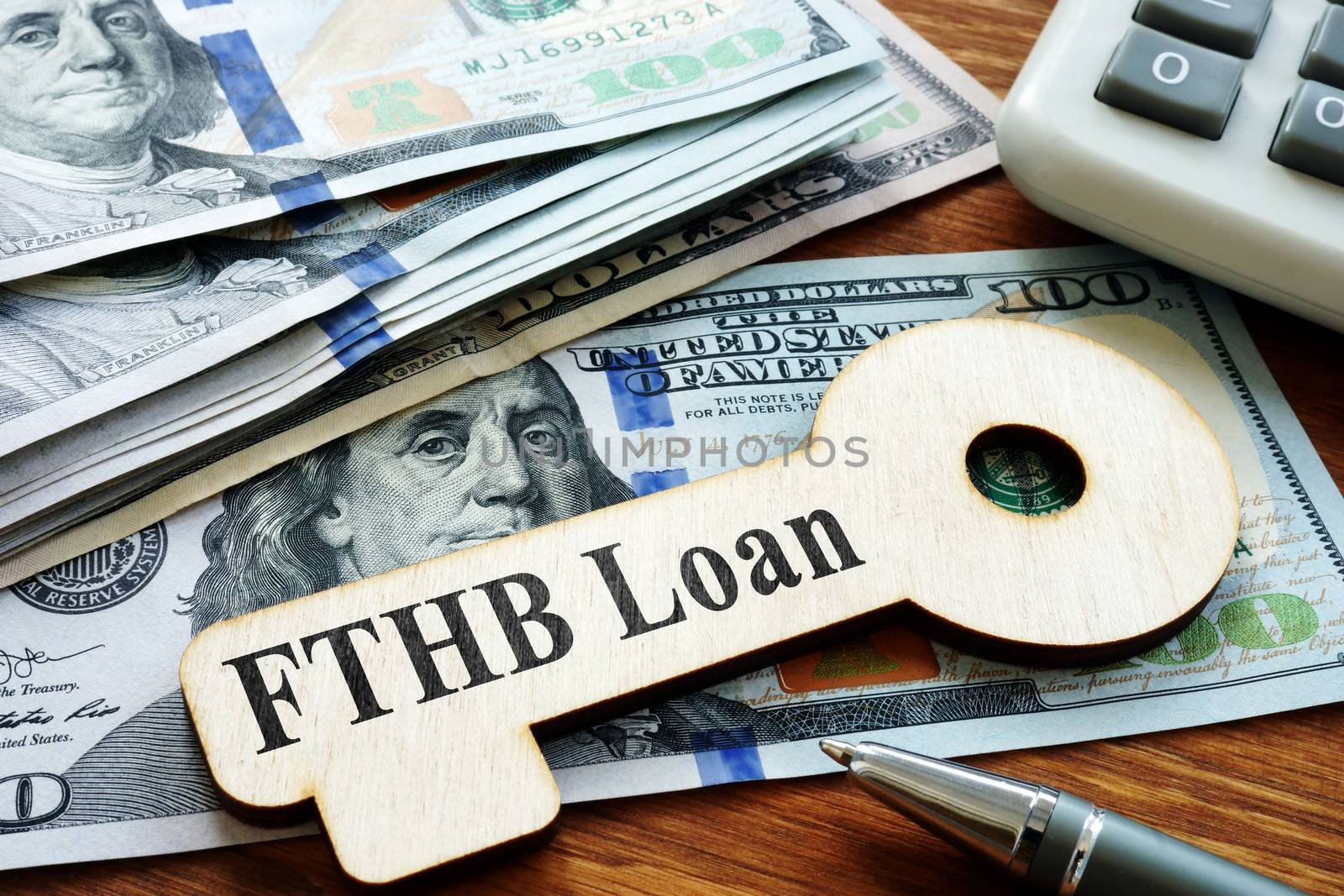 First-Time Homebuyer FTHB Loan printed on the wooden key.