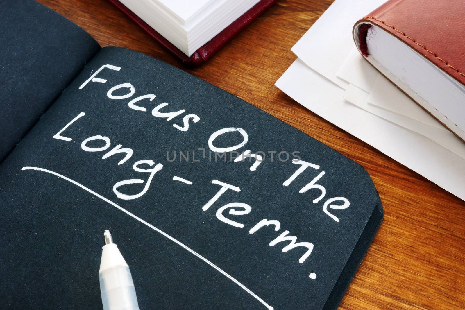 Focus on the long term written on the black page.