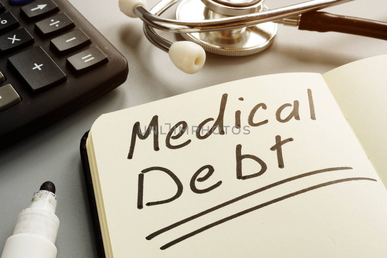 Medical debt bill and and stethoscope.