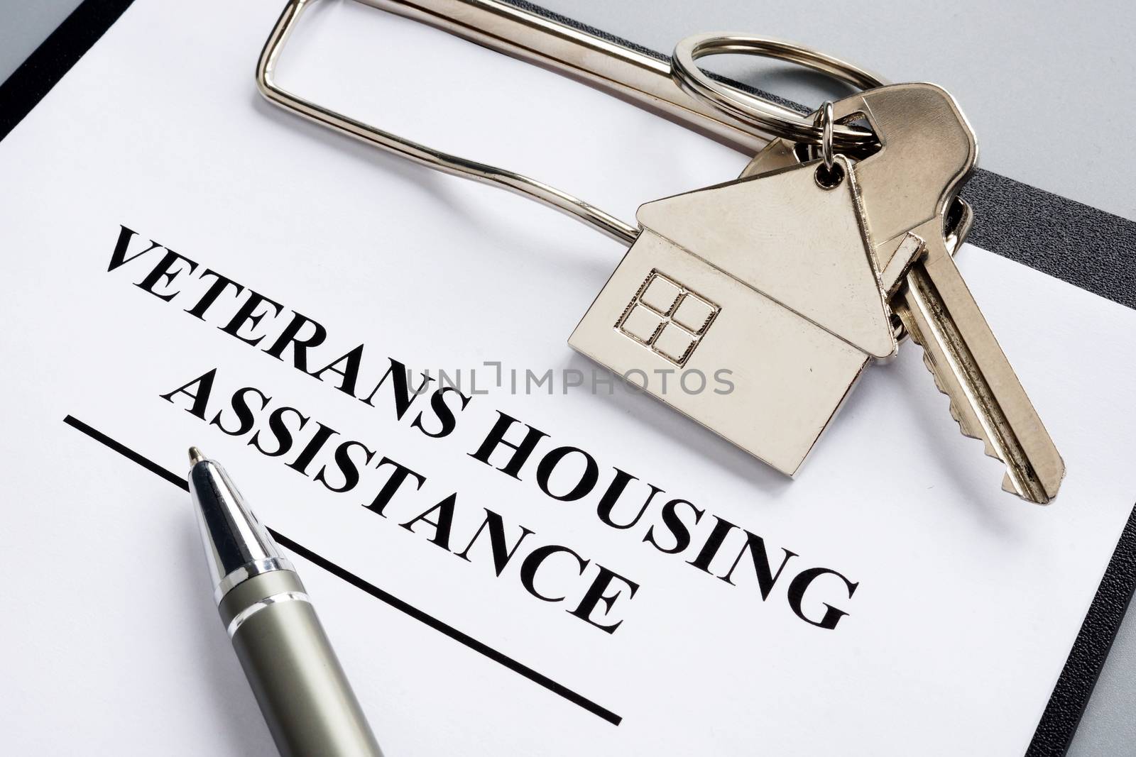 Veterans housing assistance documents and key from home.