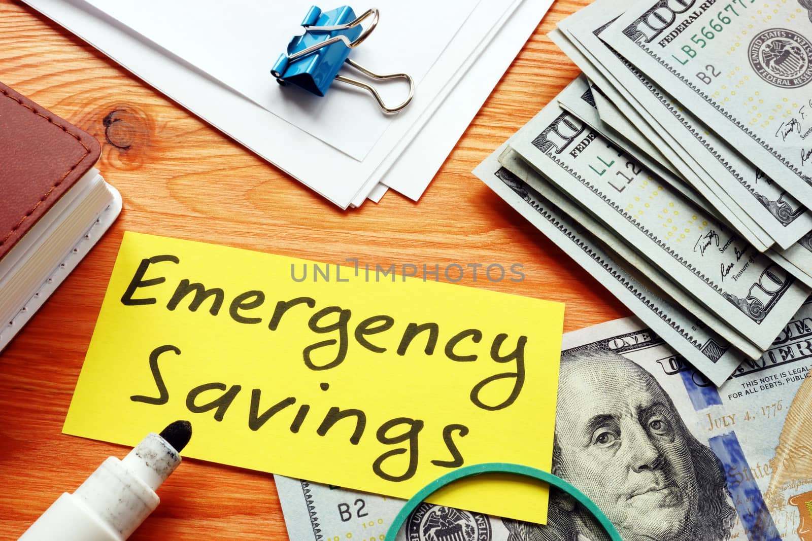 Emergency savings memo and stack of money. by designer491