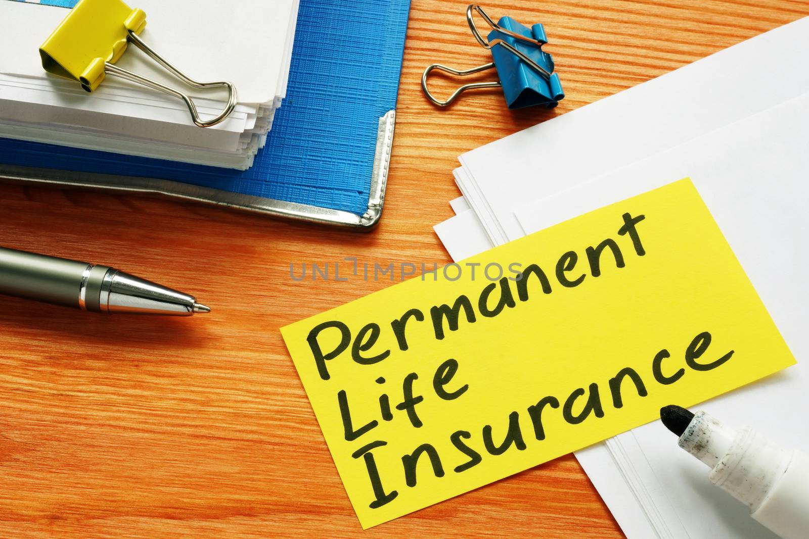 Permanent life insurance form and pen for signing.