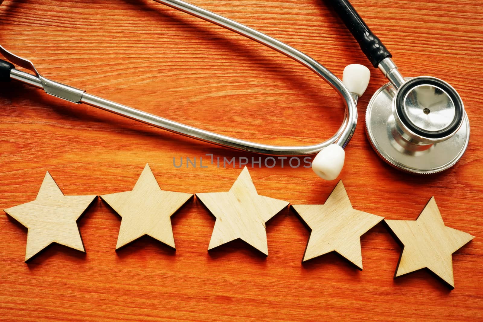 Patient experience and satisfaction concept. Stethoscope and five stars.