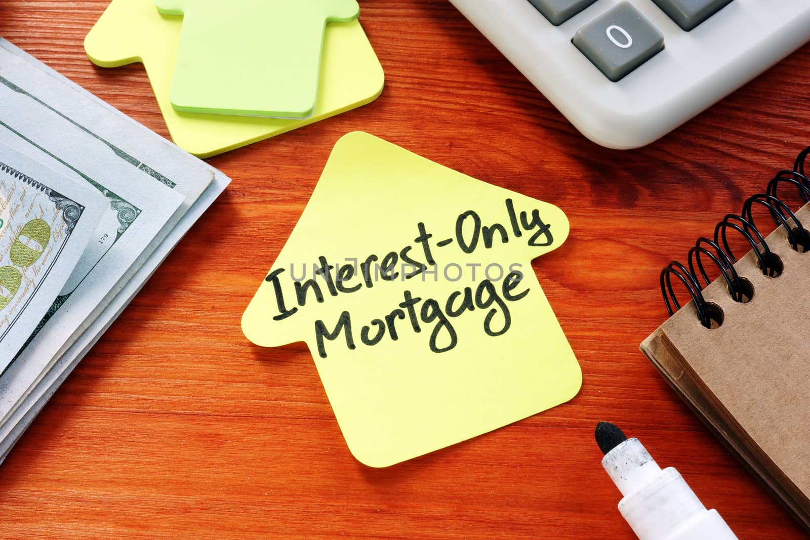 Interest Only Mortgage phrase on the paper home. by designer491