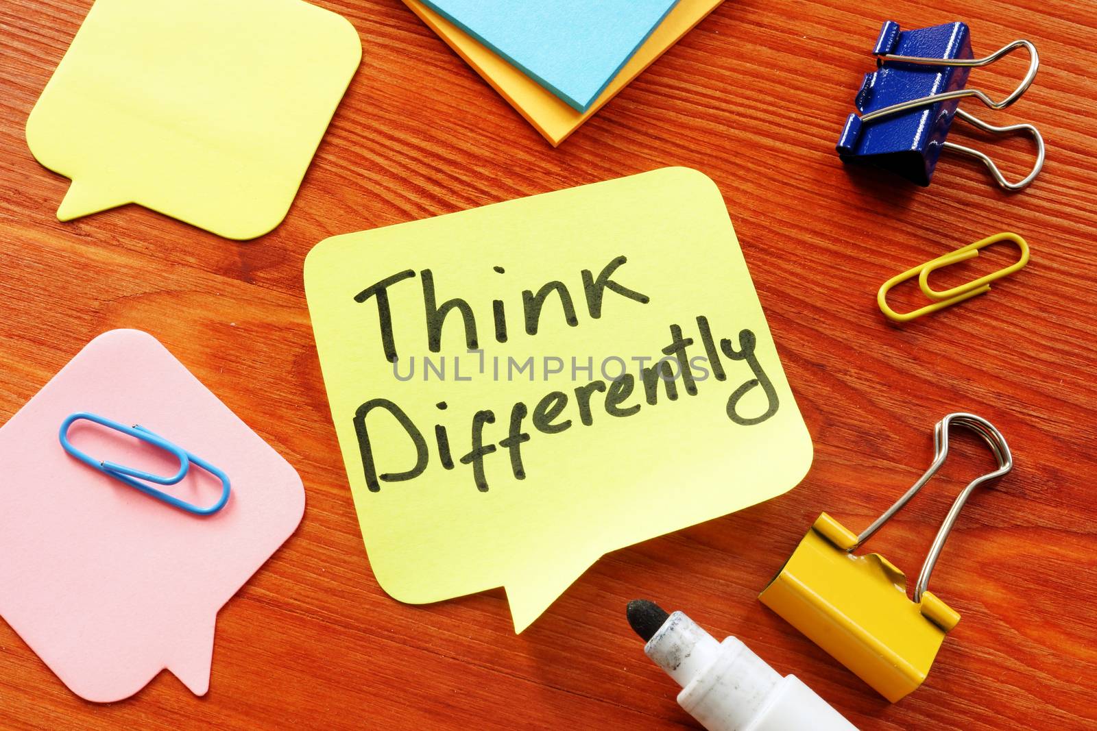 Think Differently motivation quote on the table. by designer491