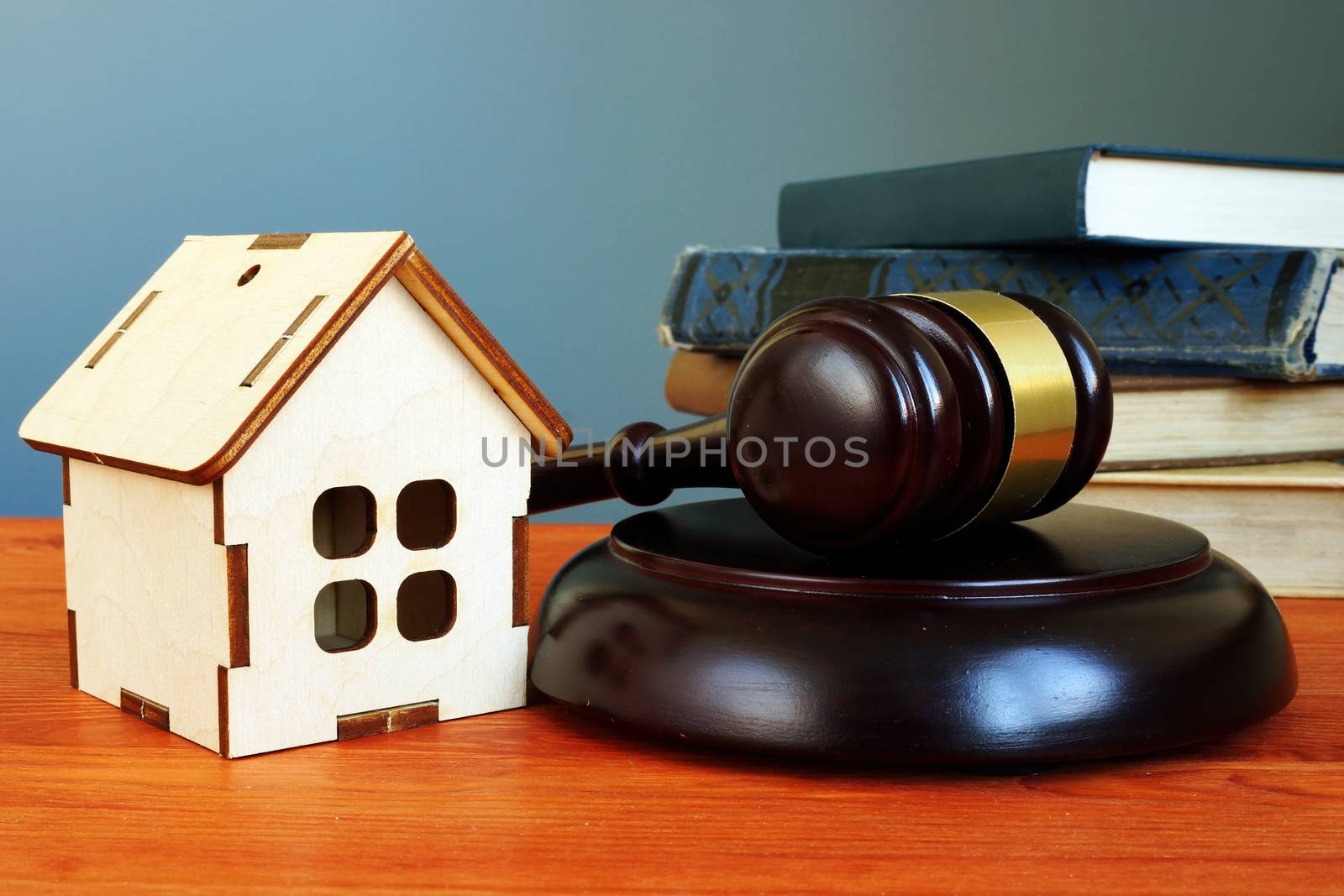 Property law concept. Gavel and tiny home on the desk.