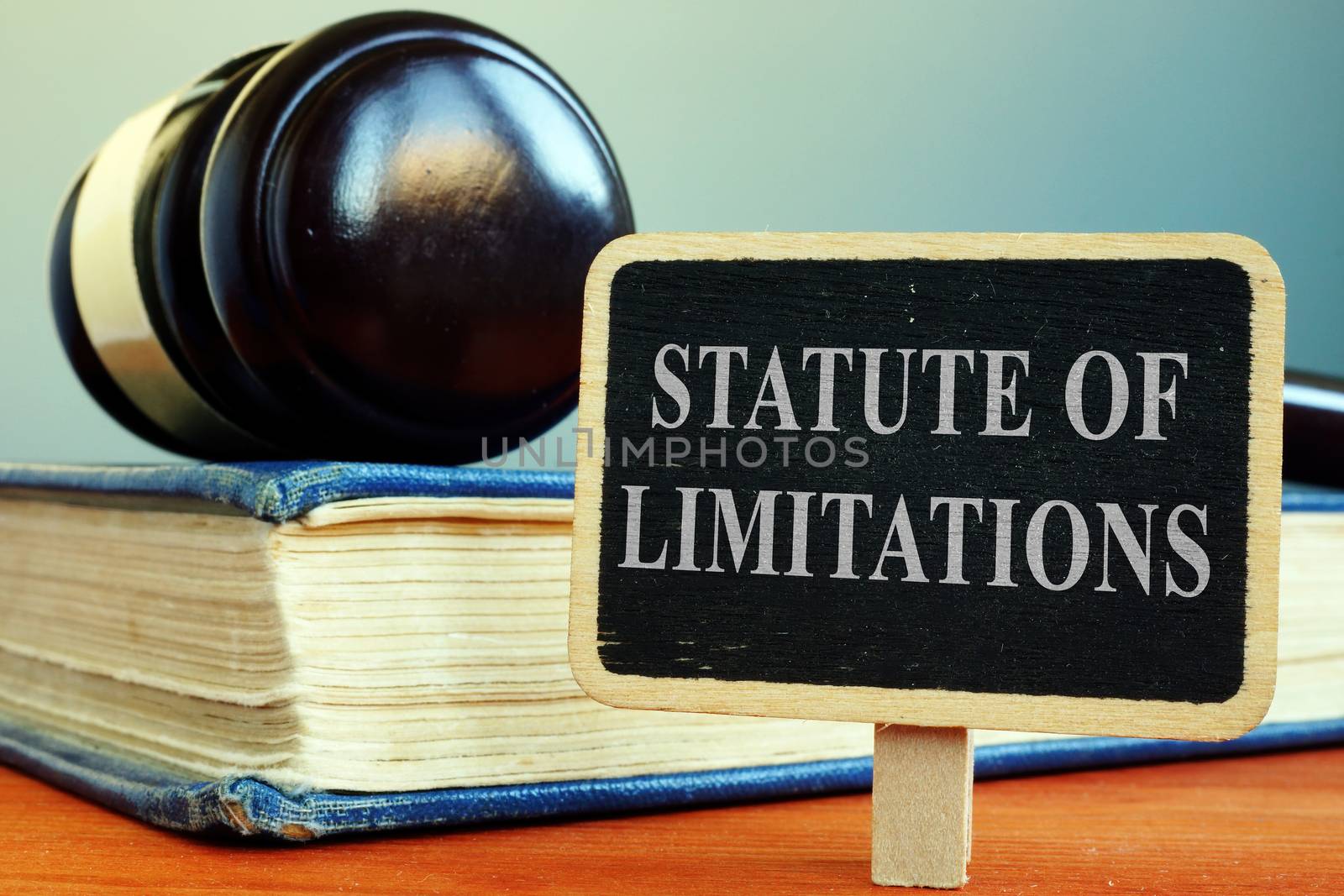 Statute of limitations sign, book and gavel.