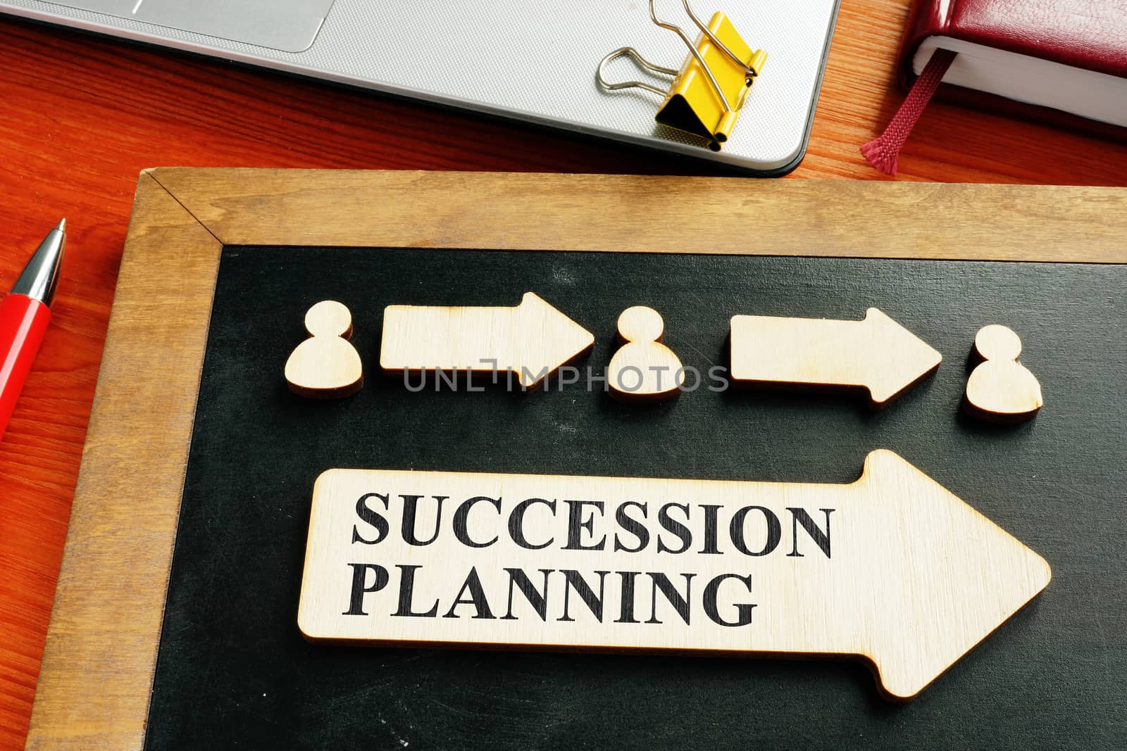 Succession planning concept. Wooden figures and arrows. by designer491