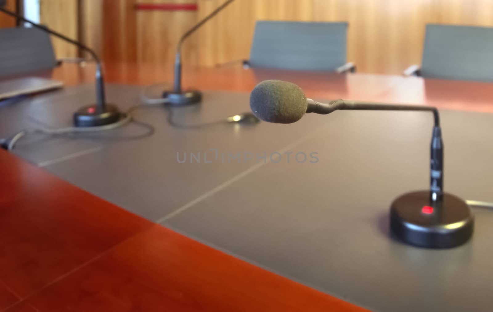 microphone on a wooden table of a boardroom by rarrarorro