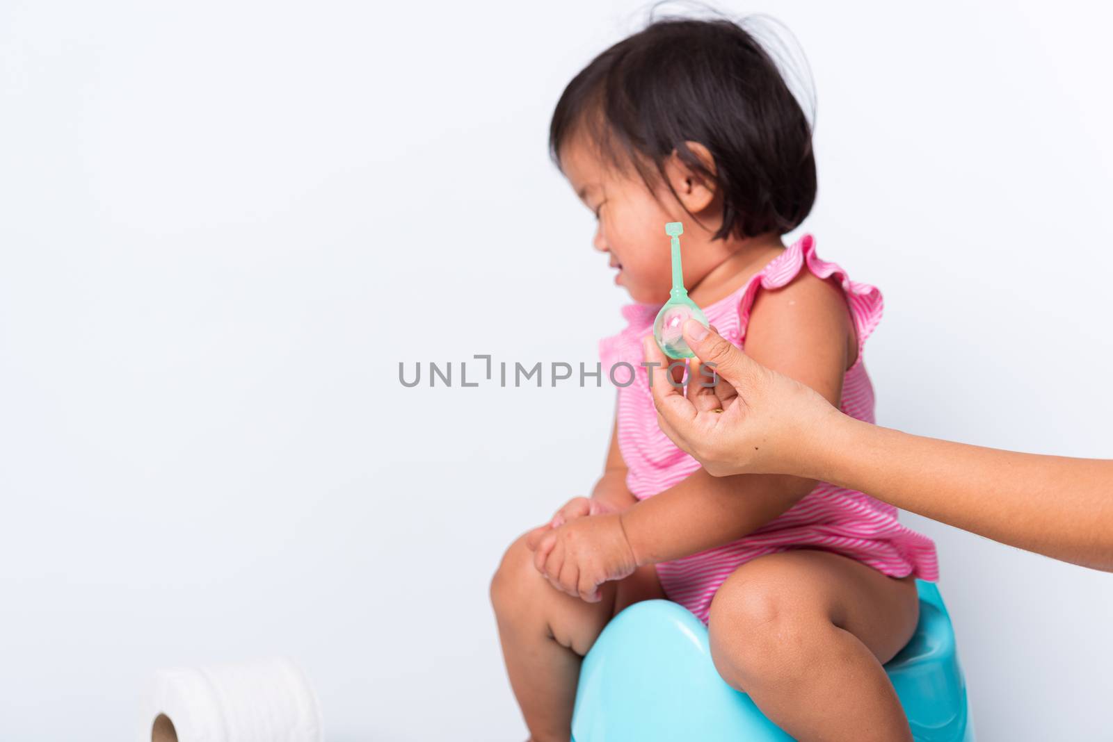 baby child girl training to sitting on blue chamber pot or potty by Sorapop