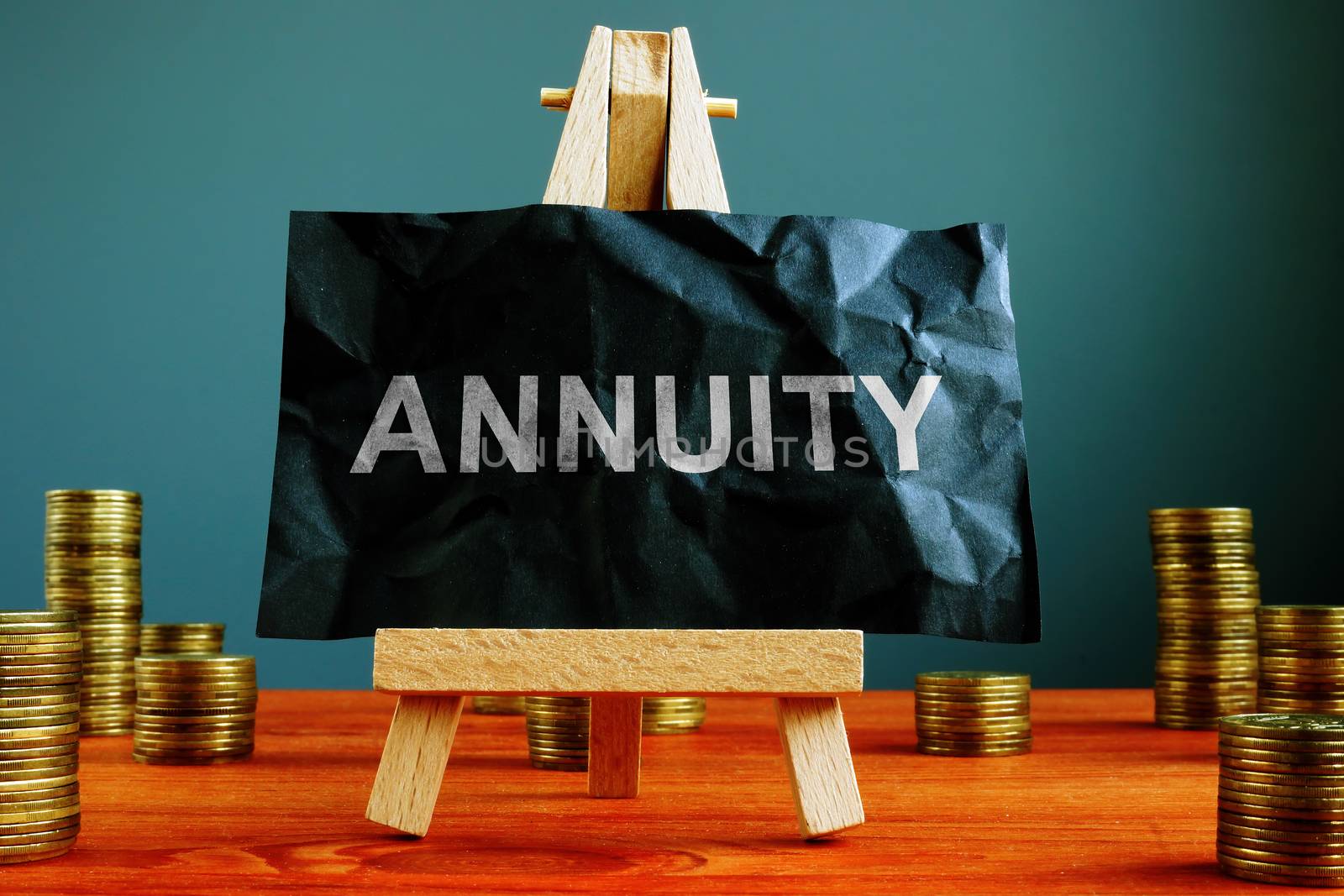 Annuity sign on the black sheet ans coins.