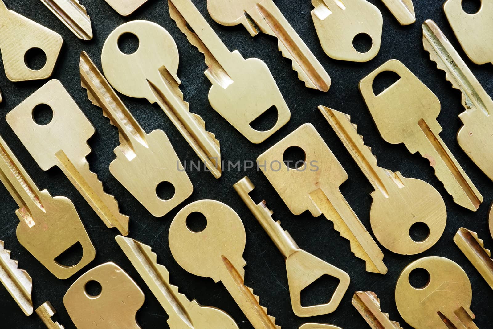 Lot of different yellow keys on dark background. Different opportunities and choices concept.