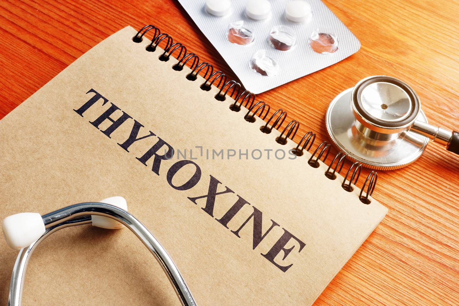 Thyroxine hormone in the notepad and stethoscope.