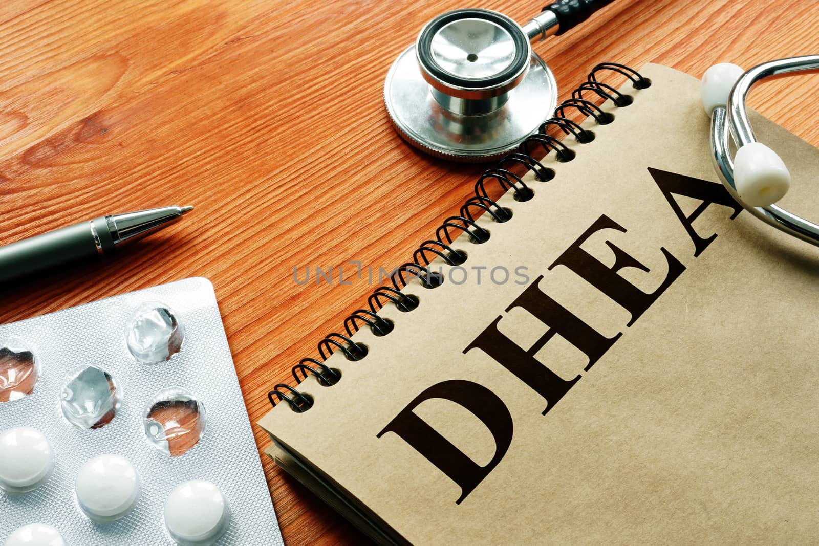 Dehydroepiandrosterone DHEA hormone and white pills.