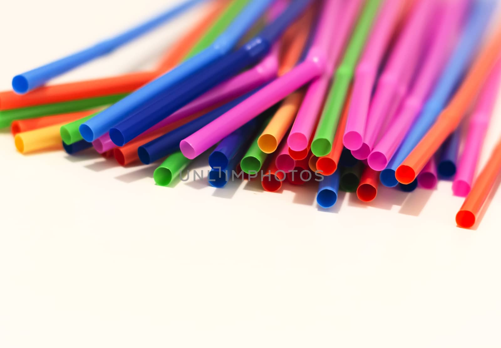 a group of colored plastic cocktail straws. Plastic and non-recyclable materials. by rarrarorro