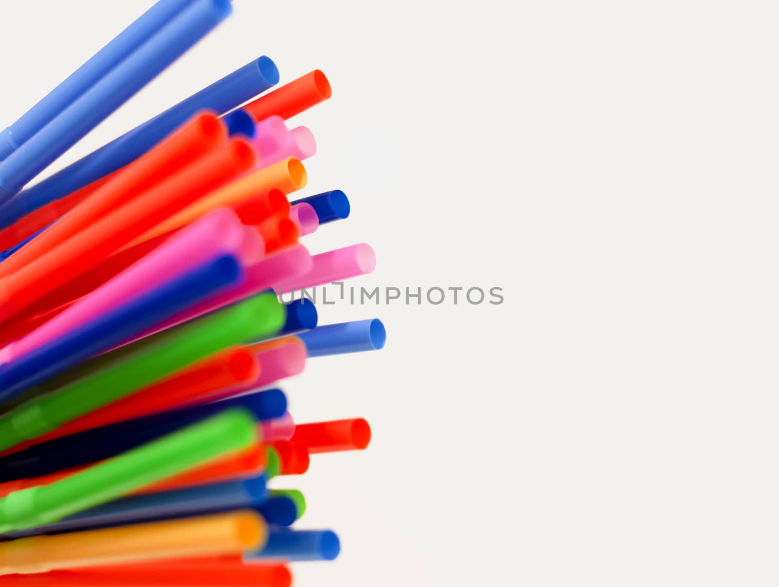 a group of colored plastic cocktail straws. Plastic and non-recyclable materials. by rarrarorro