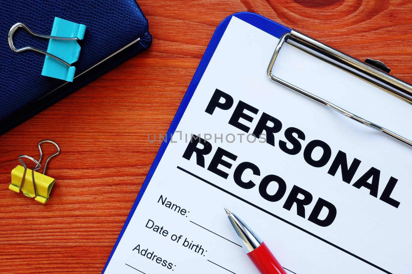 Personal records information form and other papers with pen.